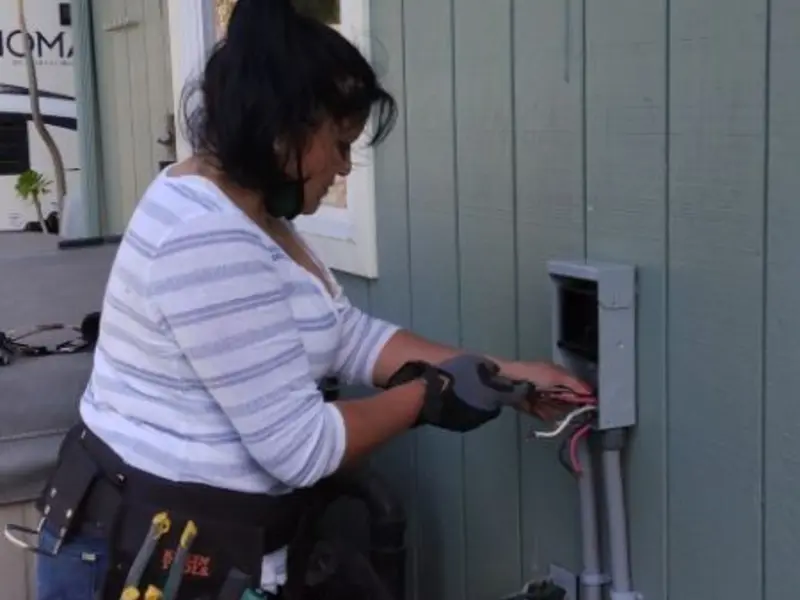 Licensed electrician wiring an exterior subpanel in Gering